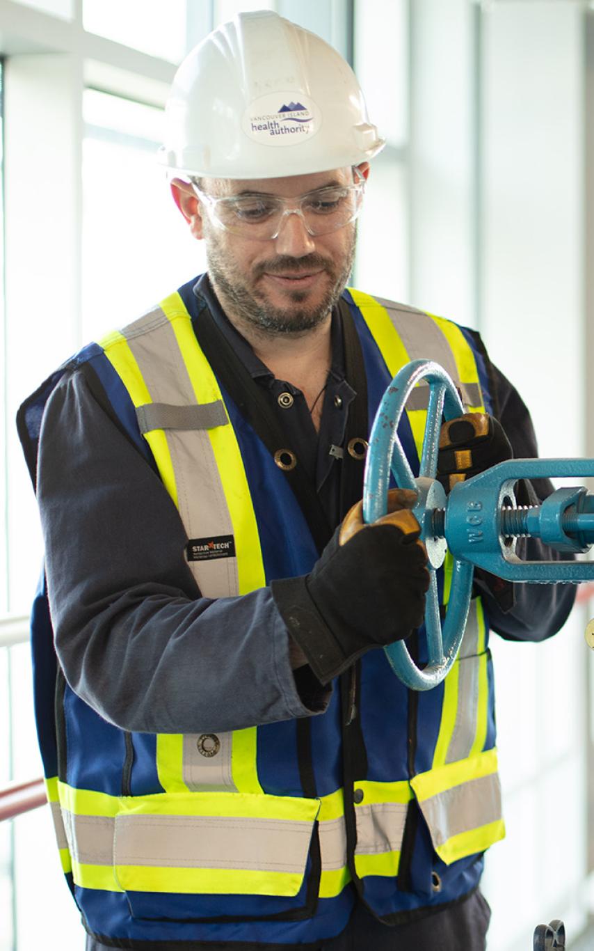 Man working with large pipe system