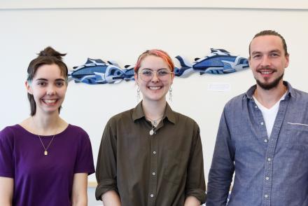 Simon Maguire, Lily Eggert and Trevor Michalchuk stand side-by-side smiling.